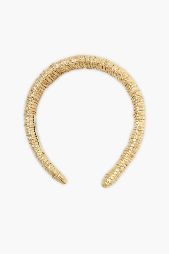 The Loeffler Randall puffy gold lamé headband features a ruched, metallic fabric that adds shine to any look.