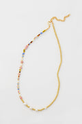 Petit Moments necklace featuring a mixed-media design with one half colorful beads, the other half small gold beads, finished with a gold chain and clasp.