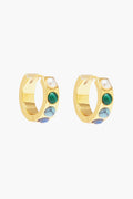 A pair of Mignonne Gavigan Gold Petra Huggie Hoop earrings embellished with a pearl and three semiprecious stones in green, turquoise, and blue hues.