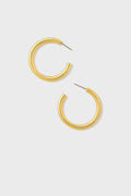 A pair of hypoallergenic gold hoop earrings by Tuckernuck Jewelry is elegantly displayed.