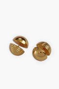 A pair of gold-toned, dome-shaped cufflinks by Cult Gaia, featuring ridged detailing on one half and crafted in a gold-plated brass finish inspired by the elegance of Gold Urbi Earrings.