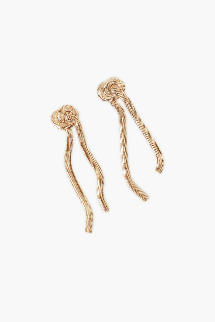 A pair of Gold Zach Earrings by Petit Moments, featuring circular tops and two dangling wavy strands—stylish twisted chain earrings from a female-owned brand.