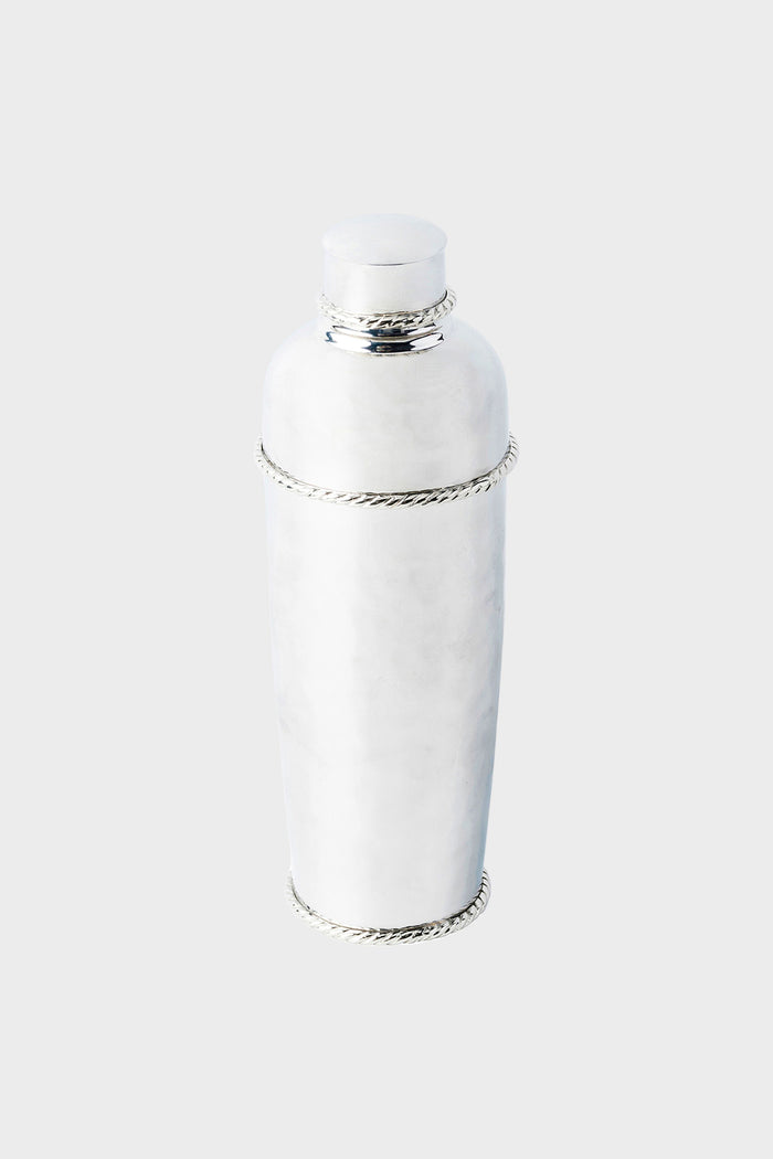 The Juliska hammered stainless steel cocktail shaker features decorative rope detailing around the lid, neck, and base—perfect for any mixologist’s collection.