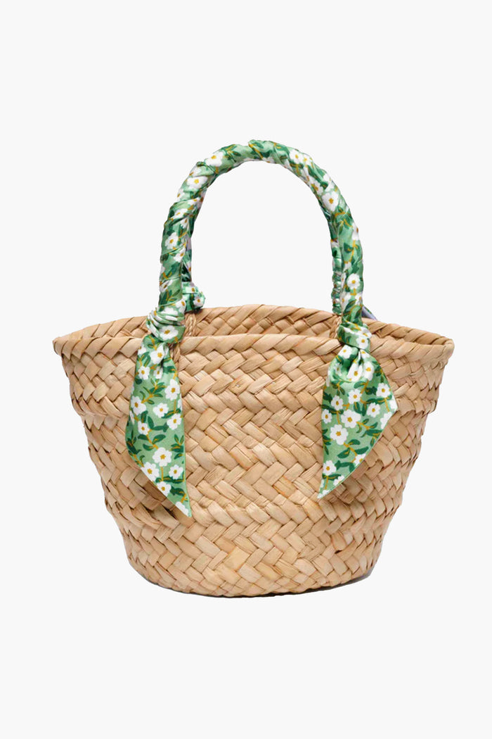 Kayu mini tote crafted from natural woven straw with dual handles wrapped in green fabric adorned with white daisies—perfect for fans of sustainable accessories.