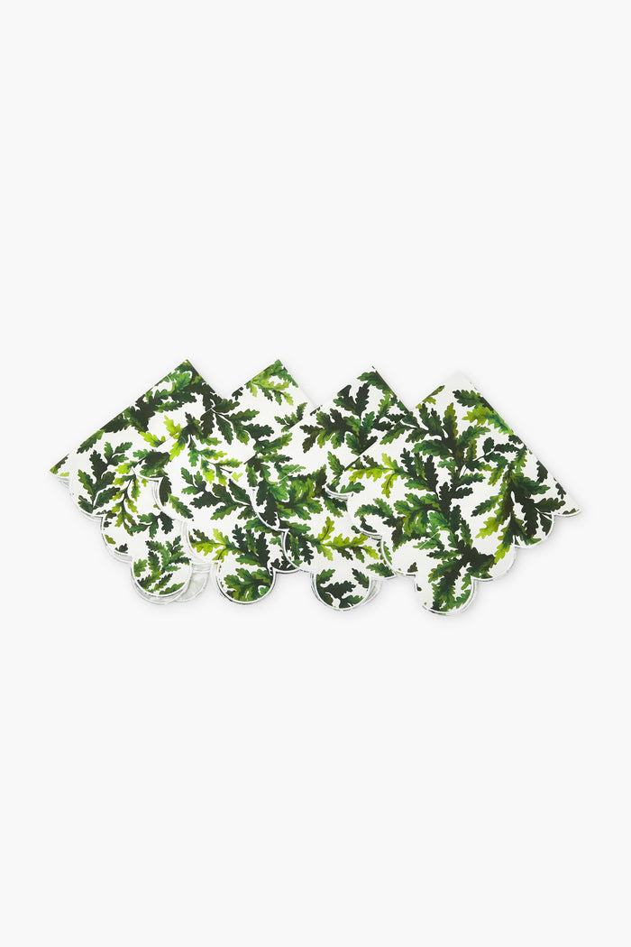 Four Chefanie Green Leaf Napkins, crafted from cotton with a charming leafy pattern and scalloped edges, are arranged in a row—perfect as a thoughtful housewarming gift.