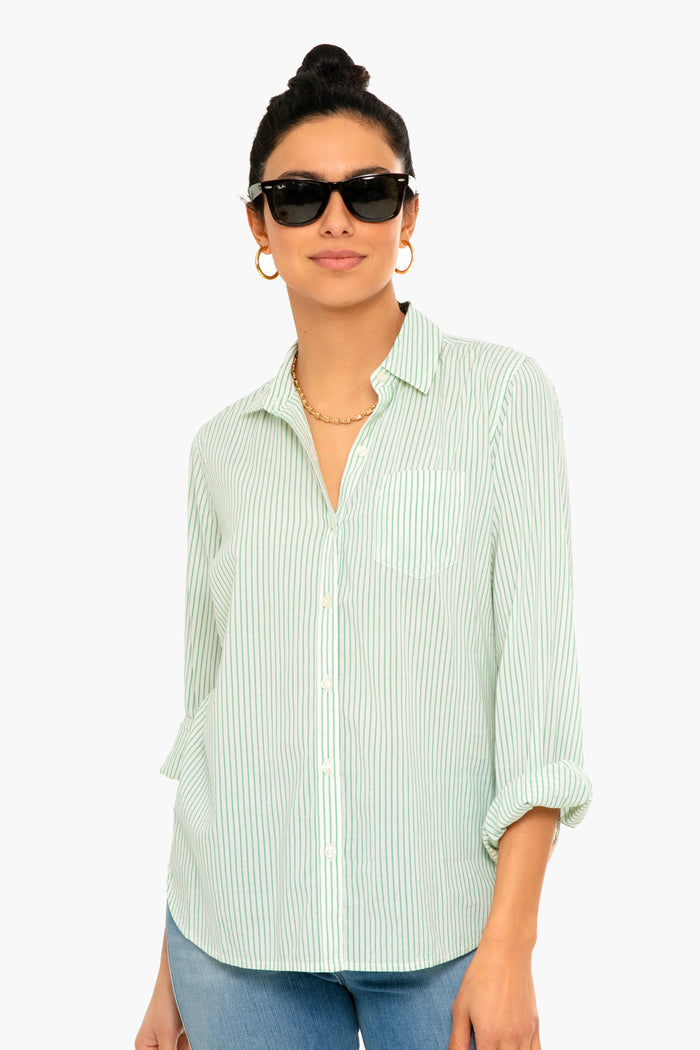 Woman wearing dark sunglasses, gold earrings, and a light green striped TROVATA Birds of Paradis Grace Classic Shirt with rolled-up sleeves.