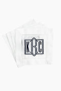 A stack of Caton's Wharf white Hemstitched Cocktail Napkins, each with an embroidered "K C" monogram and black eyeglass outline—an ideal personalized gift.