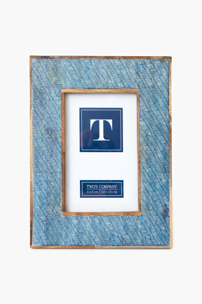 A rectangular blue and gold photo frame by Two's Company, handcrafted from mango wood with a leaf pattern, holds a 4x6 in (10x15 cm) placeholder insert.