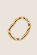 High-end Gold Sofia Bracelet with a classic spiral design, ribbed texture, and foldover clasp, offering an effortless, fun, and vintage-inspired style for everyday wear.