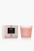 A pink NEST New York 3 Wick Candle with a box labeled "Himalayan Salt & Rosewater" is displayed, offering a luxurious home fragrance.