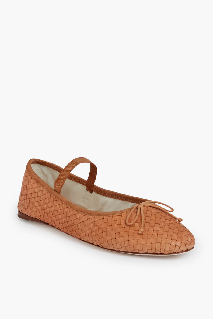 Loeffler Randall light brown woven flats, featuring a thin strap and a small bow on the toe, shown from a slight angle.