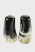 Be Home’s polished horn salt and pepper shakers feature a natural dark brown, black, and cream gradient. This handcrafted set is ideal for those who value ethically sourced home goods.