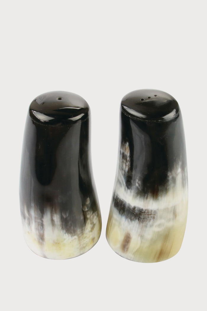 Be Home’s polished horn salt and pepper shakers feature a natural dark brown, black, and cream gradient. This handcrafted set is ideal for those who value ethically sourced home goods.