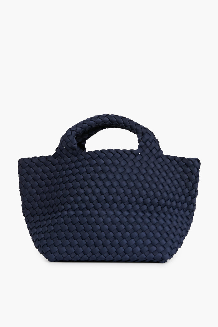 A Naghedi navy blue woven neoprene tote handbag with short handles.