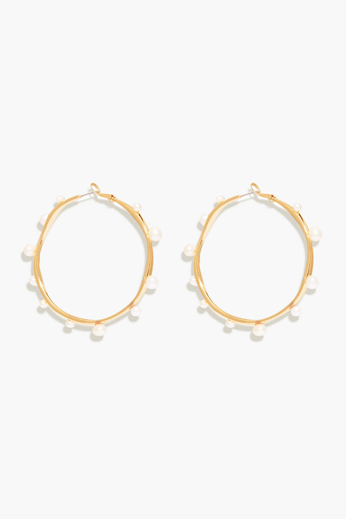 Mignonne Gavigan's Isla Pearl Hoops are gold-plated earrings accented with small, evenly spaced freshwater pearls around each hoop.