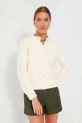 Woman wearing the Alex Mill Ivory Nico Chunky Cardigan, a cream button-up women's knitwear piece, paired with olive green shorts.
