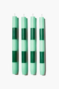 FAZEEK offers a set of four upright cylindrical dinner candles, crafted from paraffin wax, each featuring alternating light and dark green horizontal stripes.