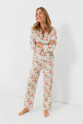 A woman stands barefoot, smiling to the side in Lalide a Paris’s matching floral cotton long-sleeve PJ set with pants, capturing the relaxed charm of French loungewear.