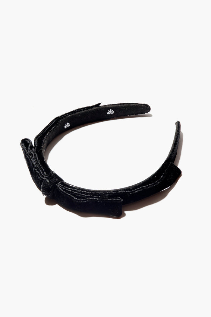 The Lele Sadoughi Jet Bardot Ribbon Slim Headband is a black velvet accessory with a side bow, adding a timeless touch.