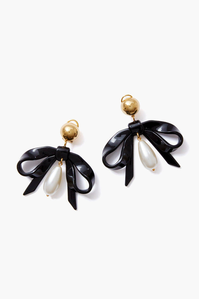 Lele Sadoughi earrings with gold studs, black ribbon bows, and two white teardrop faux pearls dangling from each bow.