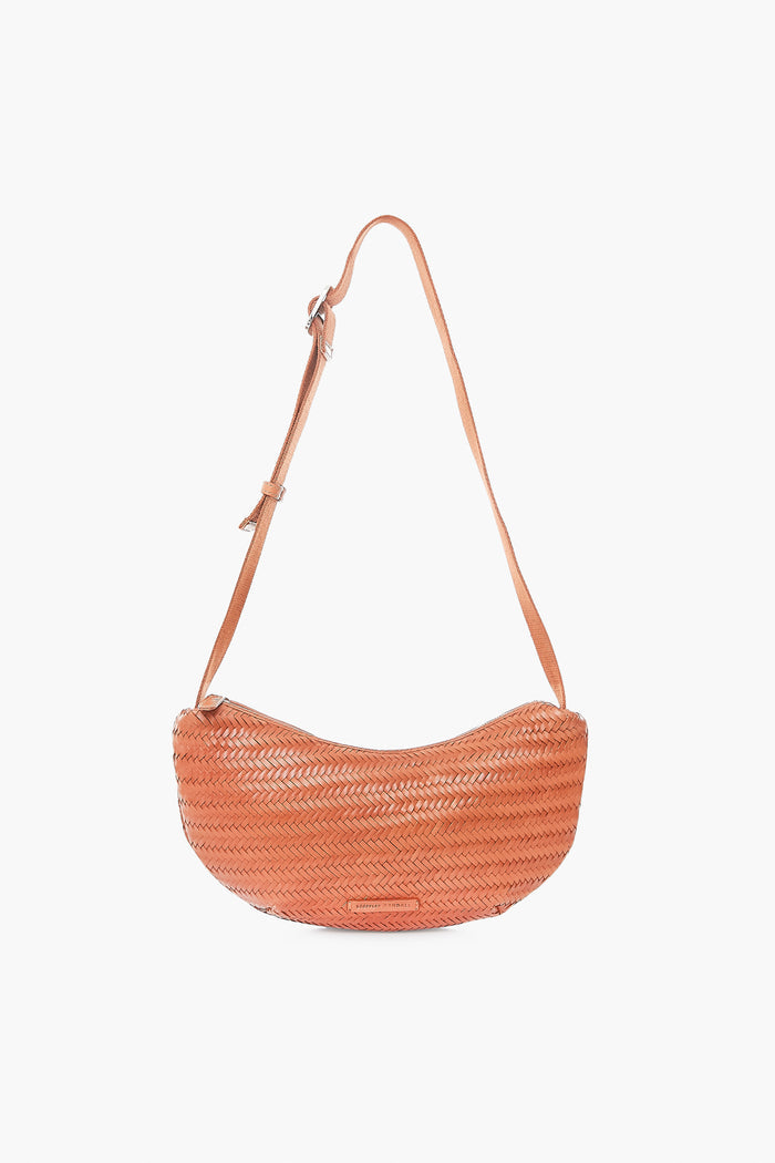 The Loeffler Randall Jillian Crossbody Pouch is a tan woven leather bag with an adjustable strap, perfect for adding effortless style to any outfit.