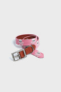 A Smathers and Branson pink needlepoint dog collar features white skull patterns, brown leather accents, and a silver buckle.