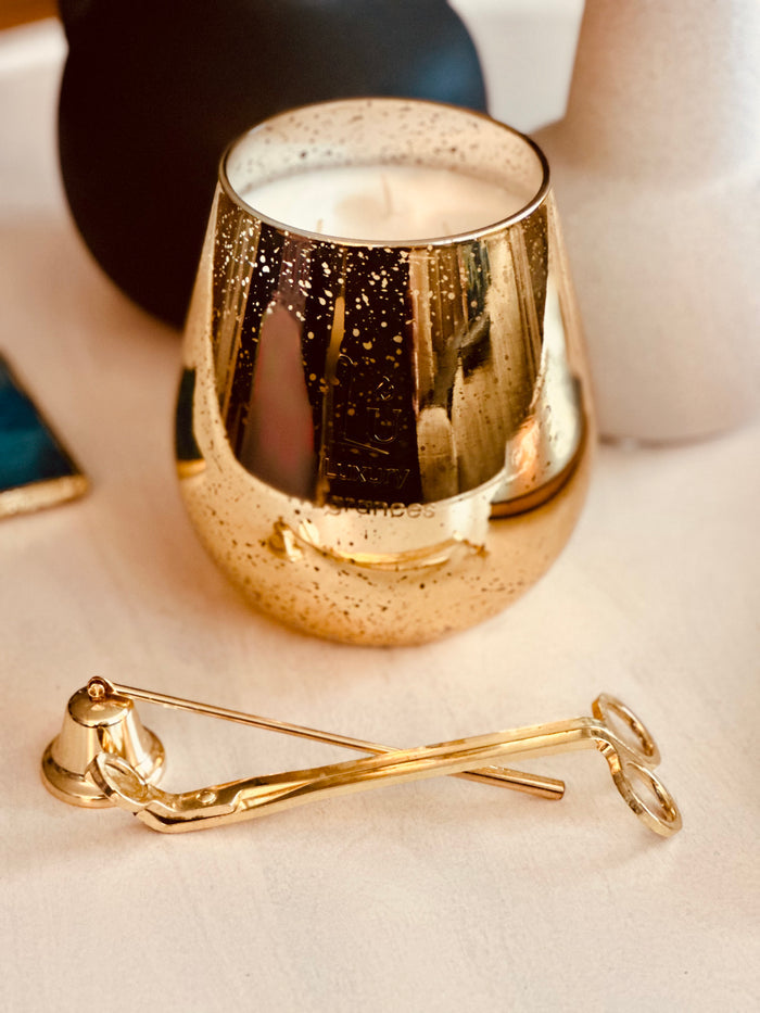 Jumbo Gold candle on a white table