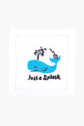 The August Morgan white cloth napkin features an embroidered blue whale, water spout, cocktail, and "Just a Splash" text—ideal as cocktail party decor or a charming hostess gift.