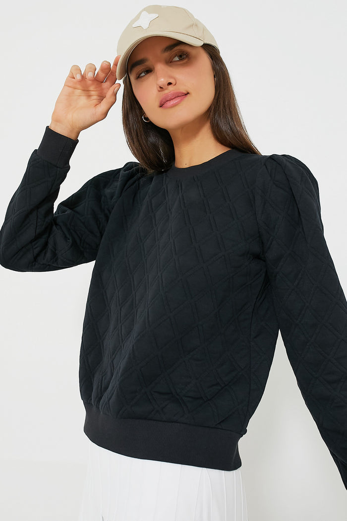 Woman in a quilted pullover, wearing the classic Khaki Collegiate Hat with a star appliqué, embodying effortless style and fun confidence.
