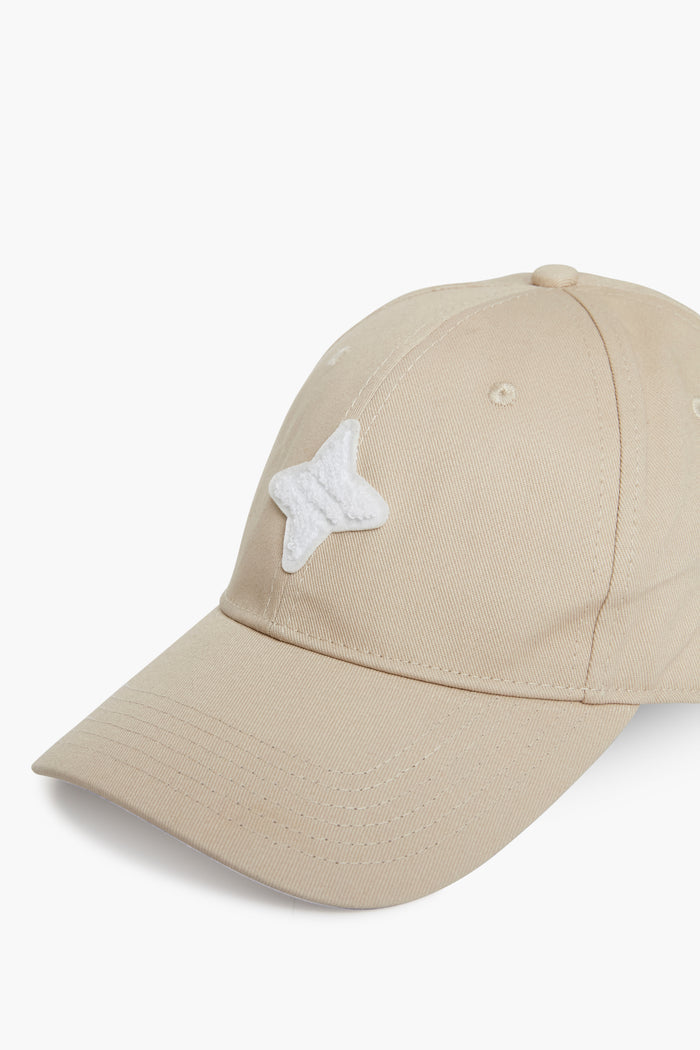 Khaki Collegiate Hat: Classic beige cap with a white star patch, adjustable back, and visible stitching. Effortless style for fun, high-end casual wear.