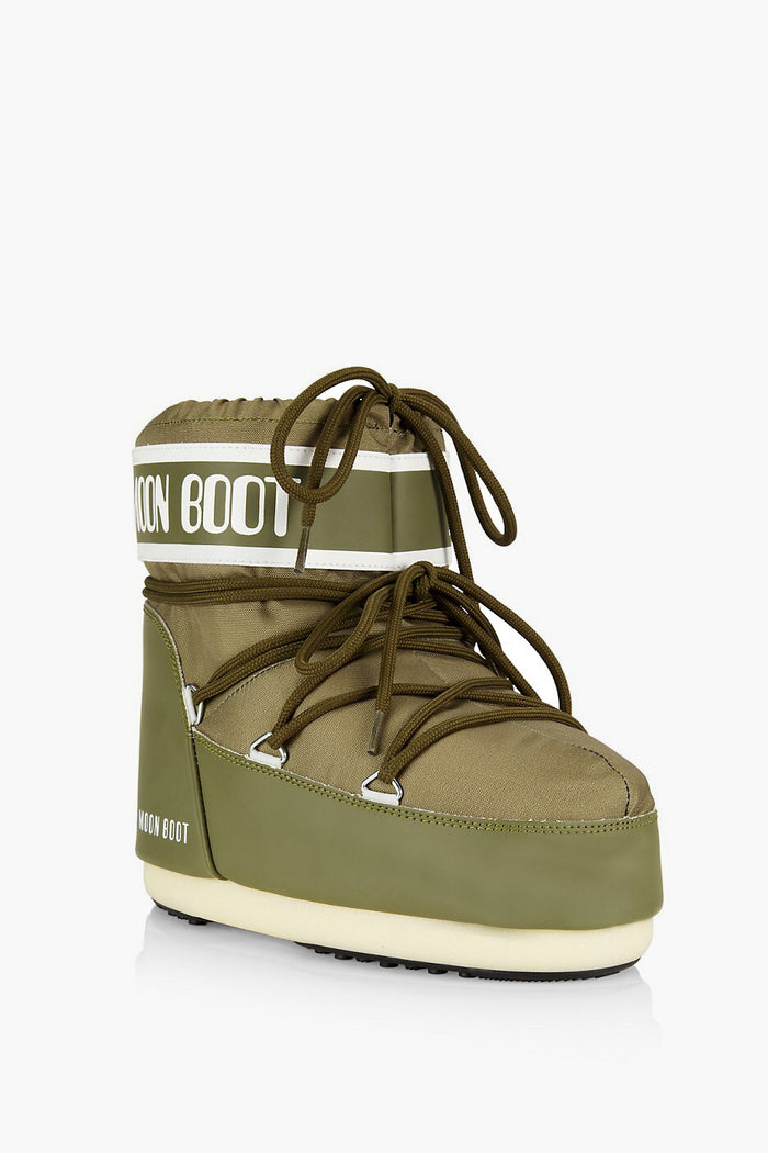 Moon Boot olive green winter boot with white sole, black trim, front laces, and iconic branding on the upper shaft—essential gear for cold-weather adventures.