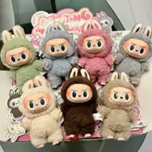 A collection of plush toy figures from the Labubu series, featuring various colors and designs, displayed in a blind box packaging.