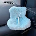 Blue fluffy car headrest cover with a white design on a car seat.