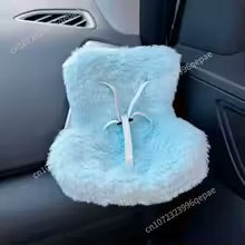 Blue fluffy car headrest cover with a white design on a car seat.