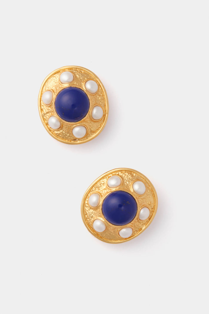 VALERE 24k gold-plated earrings feature a textured surface with central blue lapis-inspired stones, accented by small white ovals, creating an elegant pearl-like design.