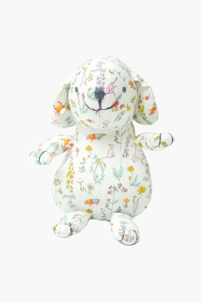 The Louelle. stuffed linen bunny features floppy ears and soft white fabric adorned with colorful floral and animal illustrations—a charming pick for nursery decor or a luxury baby gift.