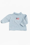 A Soft Idea light blue long-sleeve cotton baby sweater with an embroidered American flag and subtle chest text. Made in the USA and machine washable.