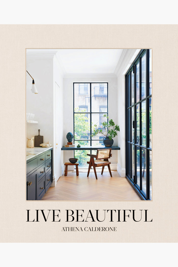 Cover of Live Beautiful by Athena Calderone, published by Abrams Books, features a bright, modern interior with large windows, a chair, a desk, and decor—an inspiring design book for home decor enthusiasts.