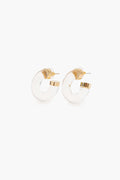 A pair of small, clear Lucite Chubby Hoops with gold-toned accents and posts from woman-owned Los Angeles brand Petit Moments.
