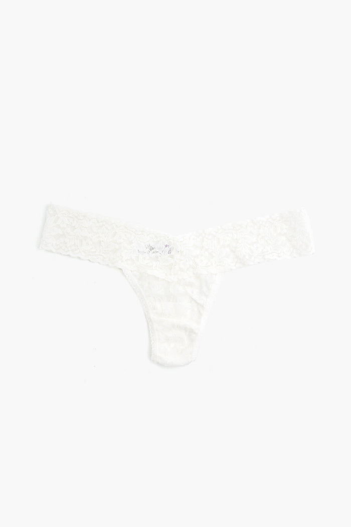 A white Hanky Panky low-rise thong crafted from stretch lace is shown laid flat.