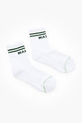 A pair of white crew-length Tnuck Sport Match-Maker socks with green stripes and green text near the top.