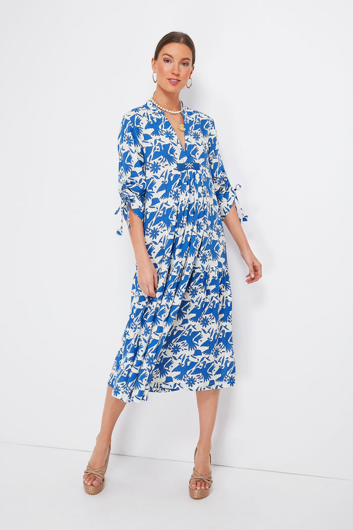 Woman wearing a Nimo With Love blue and white floral Catmint Dress with 3/4 sleeves, tan heeled sandals, and a beaded neckline.