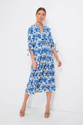 Woman wearing a Nimo With Love blue and white floral Catmint Dress with 3/4 sleeves, tan heeled sandals, and a beaded neckline.