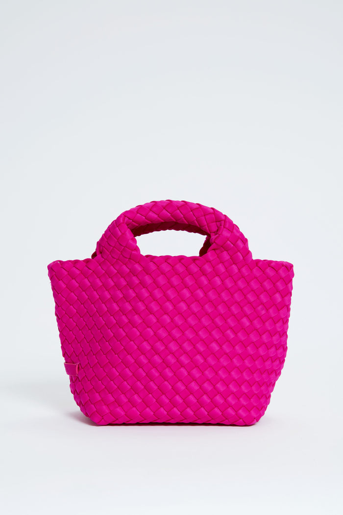 Bright pink woven Naghedi St Barths Petit handbag featuring two short handles.
