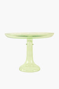 The Estelle Colored Glass cake stand, crafted from hand-blown translucent light green glass, features a wide flat top and sturdy pedestal base, lending your table a luxurious stemware-inspired look.