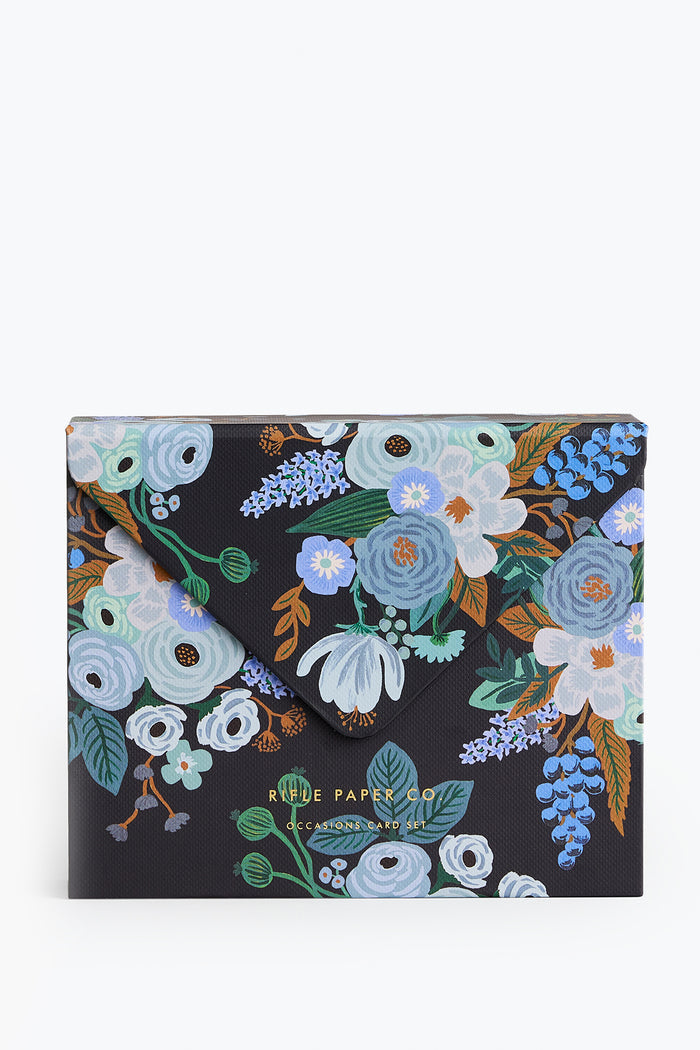 Rifle Paper Co.’s black envelope-style folder features a vibrant floral pattern in blue, white, and green with gold foil branding on the front—perfect for storing your boxed or greeting card sets.