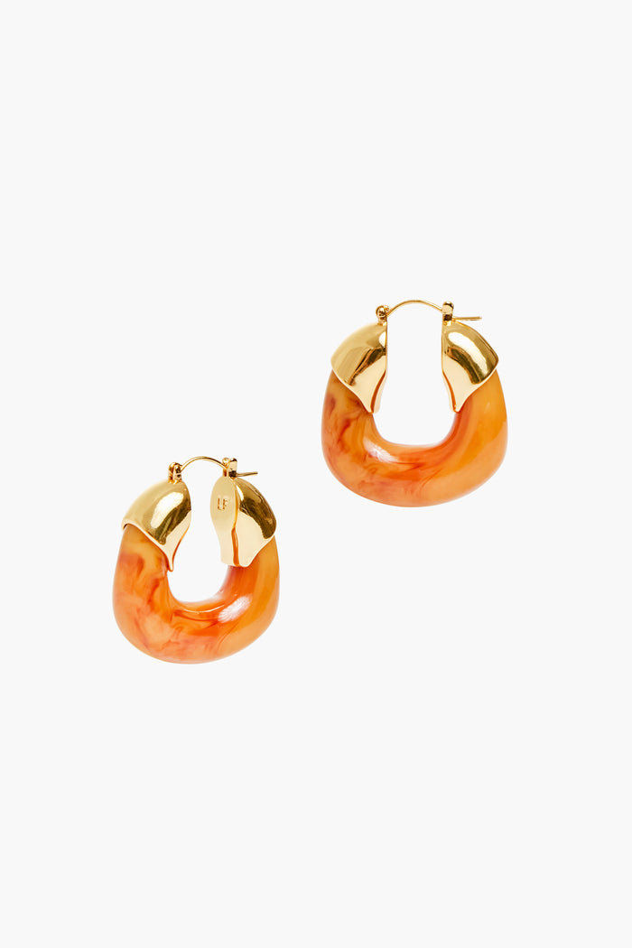 Lizzie Fortunato's Mocha Organic Hoops combine gold-plated brass on top with marbled orange acrylic below, bringing a bold and vibrant accent to your look.