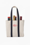 CB Station canvas wine carrier with navy handles and "BYO" embroidered on the front, holds four wine bottles.