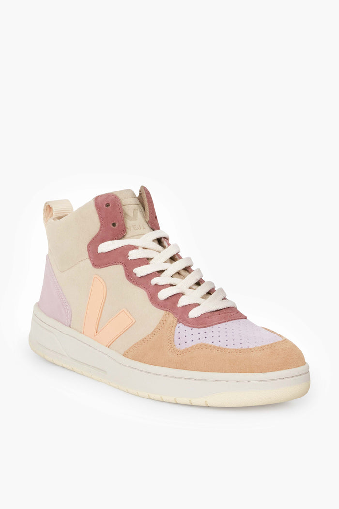 The VEJA high top sneaker is sustainably made with a pastel palette—beige, pink, and peach panels—paired with white laces and a cream-colored sole.