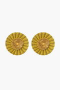 Ana Carolina Valencia's gold-plated iraca palm earrings feature a concentric circular design, perfect for fans of handmade jewelry.
